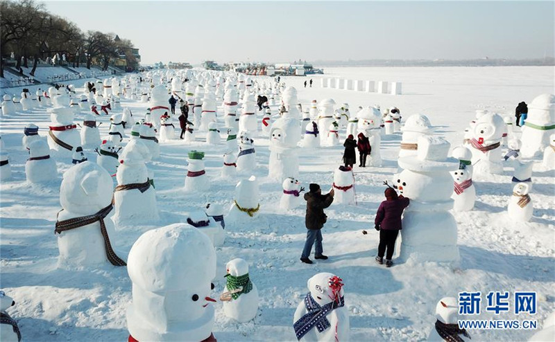 1月2日，市民、游客在雪人群中游玩觀賞（無人機拍攝）。2019個各式各樣的雪人，近日在冰城哈爾濱市的松花江畔亮相，引來眾多市民游客游玩觀賞。新華社記者 王建威 攝